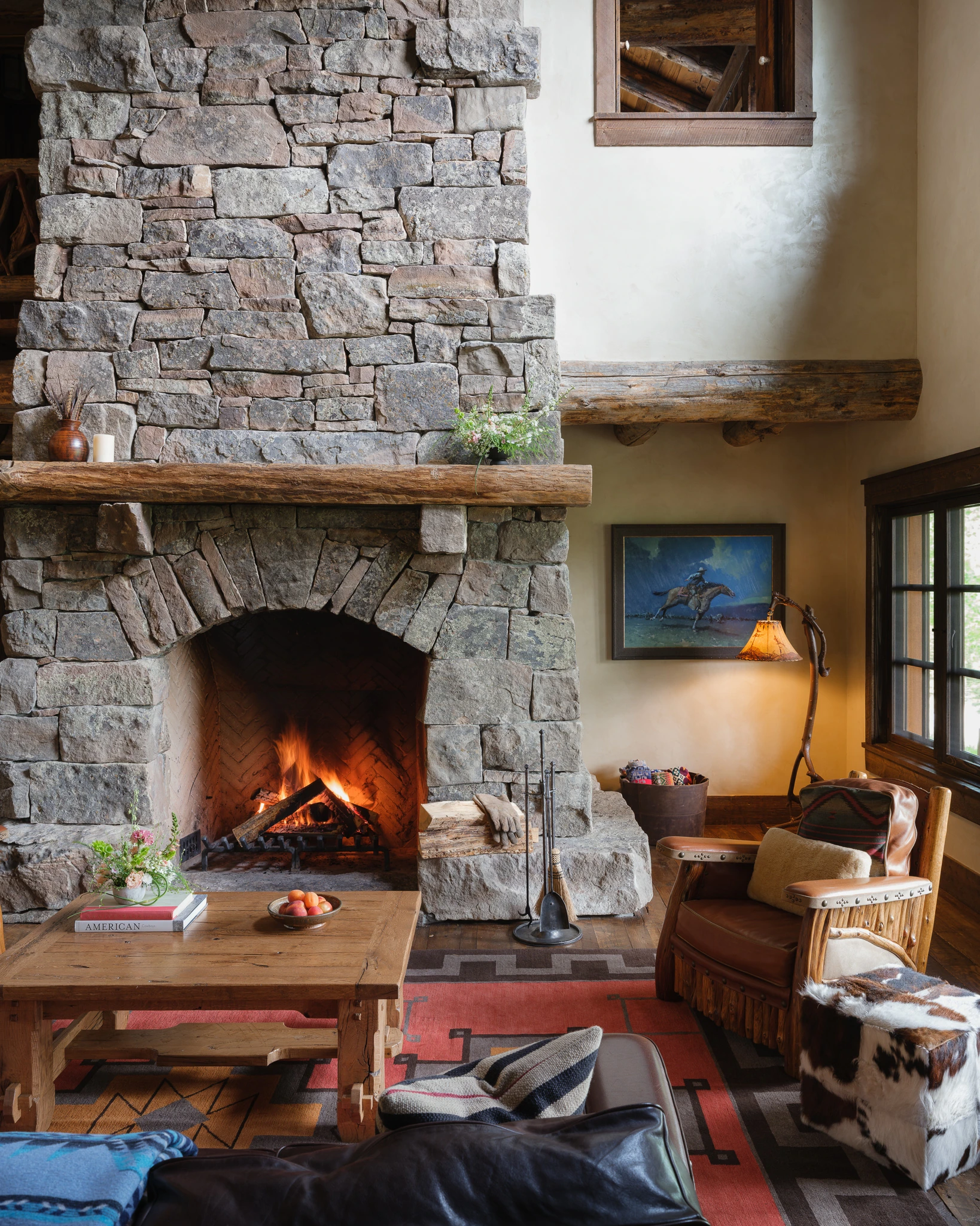 Stacked stone fireplace and reading nook — interior design photography Big Sky Montana, Pearson Design Group
